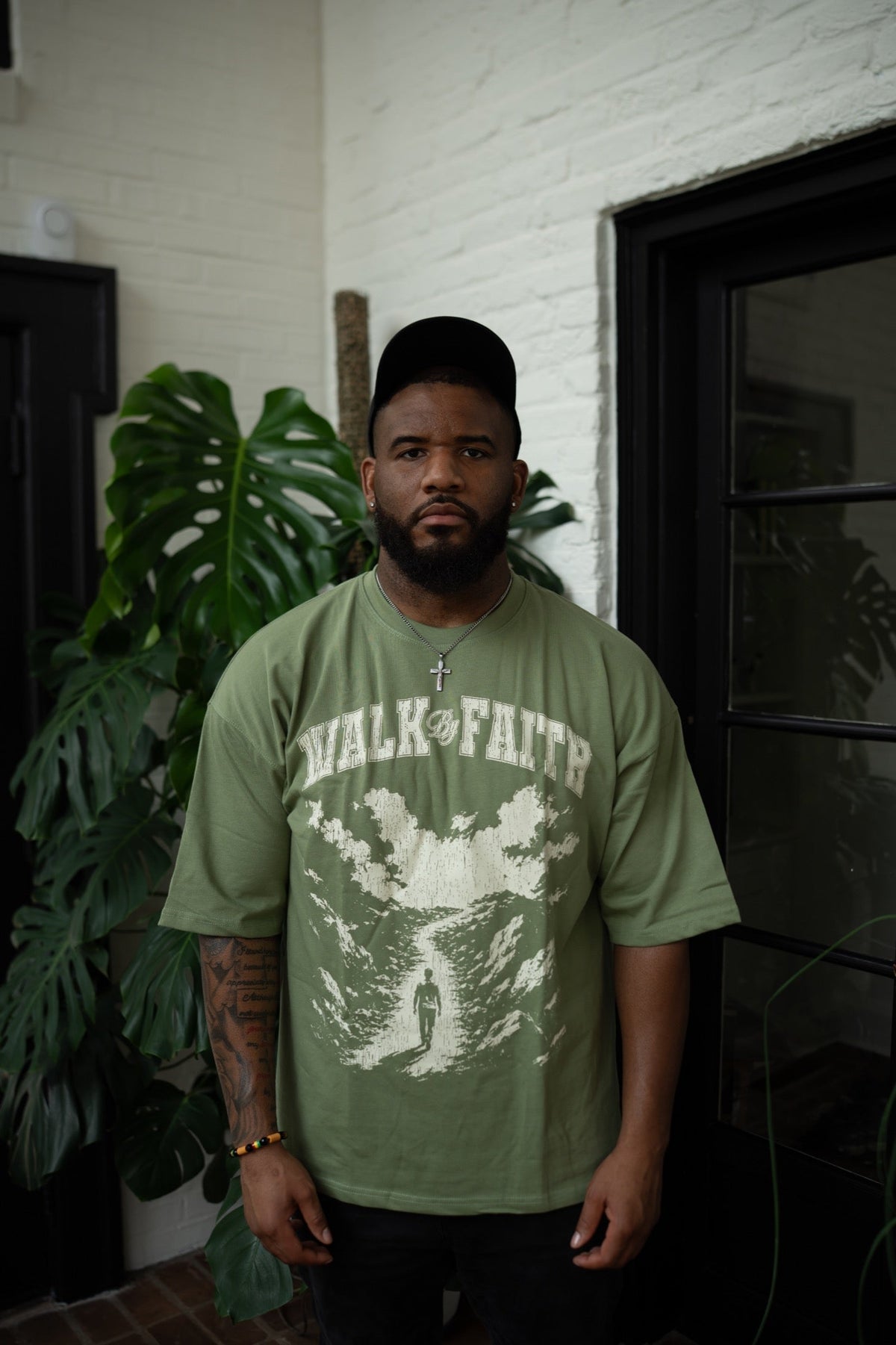 Close model photo of the Walk By Faith Tee in green